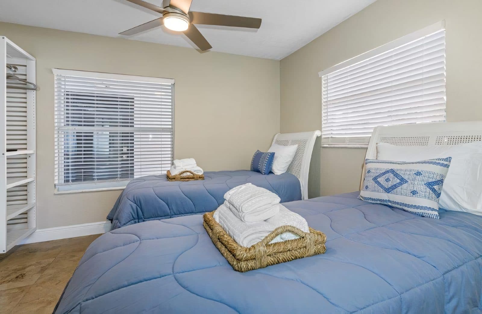 A staged short-term rental bedroom with fresh towels, ready for check-in